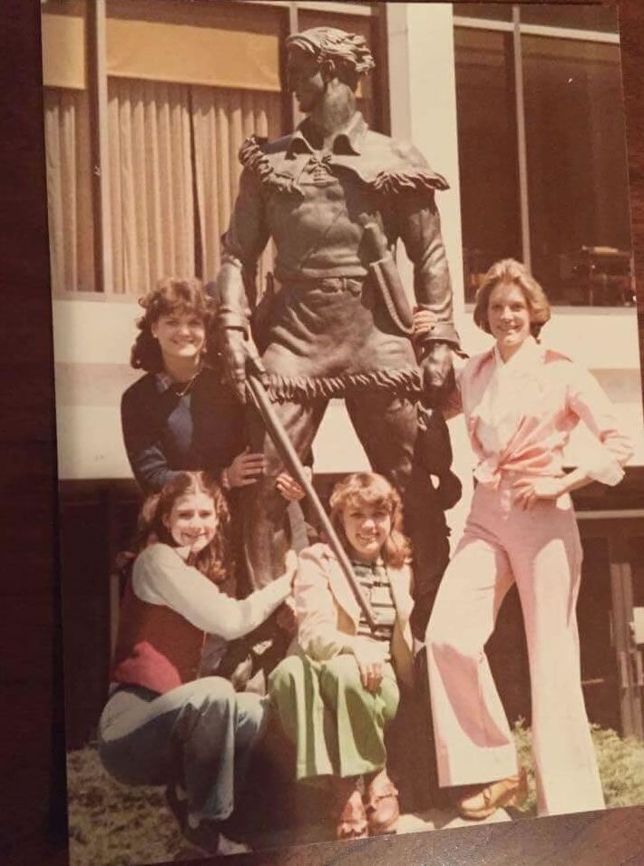Female students with Mountaineer statue