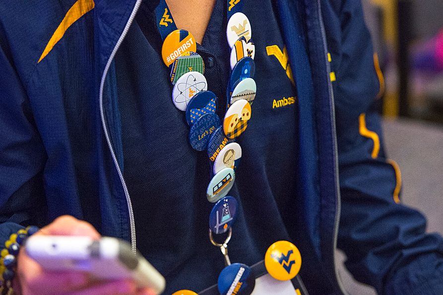 A student wearing tens of buttons on a name tag