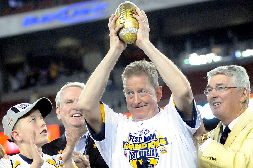 Bill Stewart raises gold Fiesta Bowl football