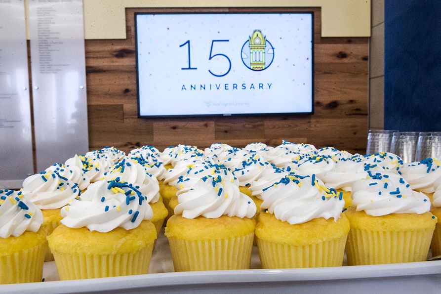Cupcakes in front of 150 anniversary sign