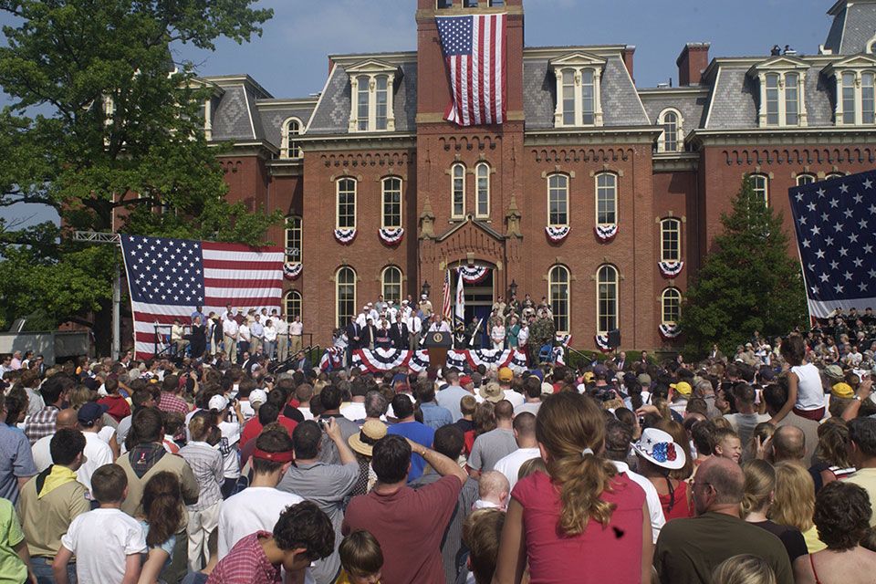 Crowd listens to speech in front of Woodburn Hall