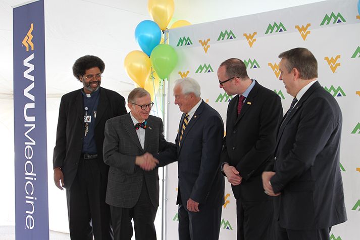 President Gordon Gee shaking hands during a photo opportunity at a WVU Medicine event