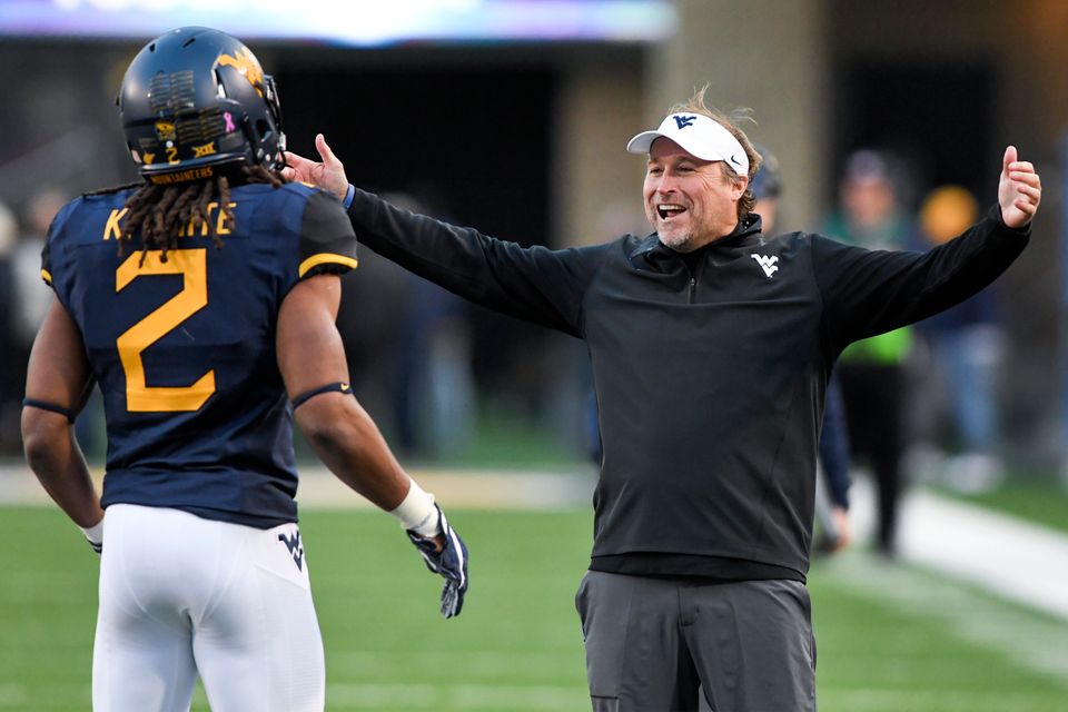 WVU coach Dana Holgorsen getting ready to embrace a player after a big play