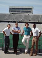 Football Coach Don Nehlen with players at Mountaineer Field