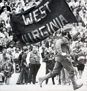 Mountaineer mascot carries West Virginia flag