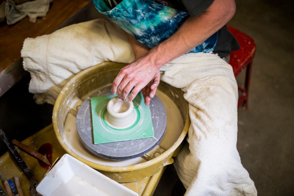 A man shapes a clay pot 