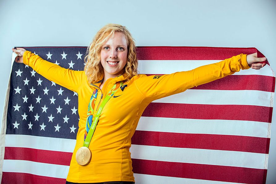 Ginny Thrasher with medal and US flag