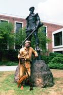 Rock Wilson next to Mountaineer statue