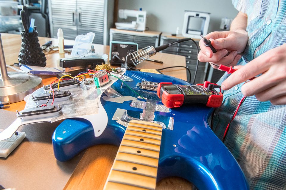 A student working on a guitar 