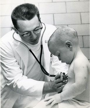 Medical student examining child